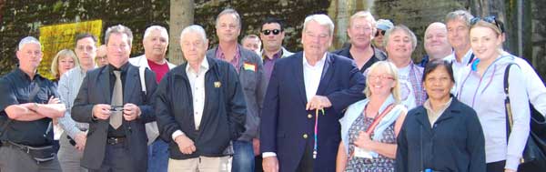 David Irving (center) pauses yesterday for a photo of his international group outside the entrance to the Hitler's gigantic fortified bunker 2013